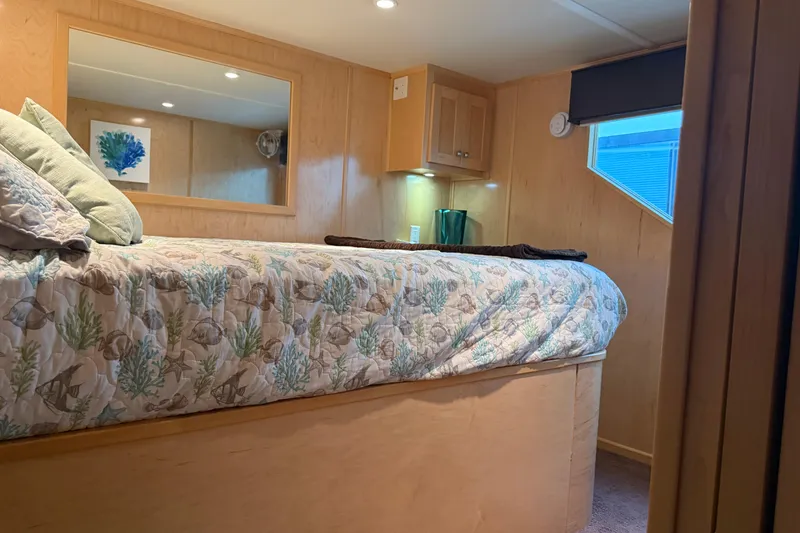 Slide: The Image of Cozy bedroom in 2015 STARDUST Oceans Share #2 houseboat with nautical-themed bedding. - 39