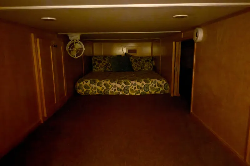 Slide: The Image of Cozy cabin bedroom in STARDUST Oceans Share #2, 2015, with floral bedding and wood paneling. - 41