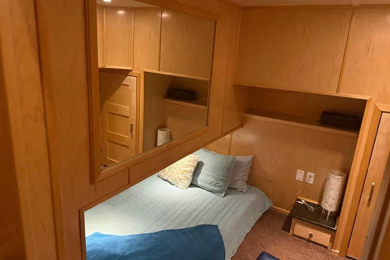 Slide: The Image of Cozy bedroom with wooden paneling, featuring a neatly made bed and soft lighting. - 44