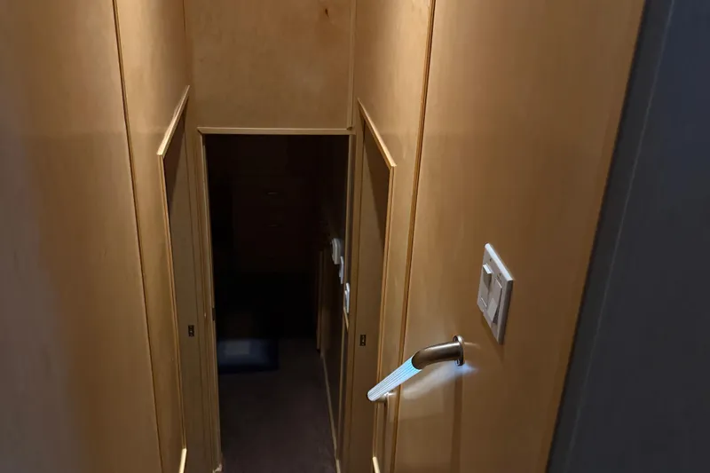 Slide: The Image of Narrow wooden stairway with handrail, leading to a dimly lit lower area. - 49