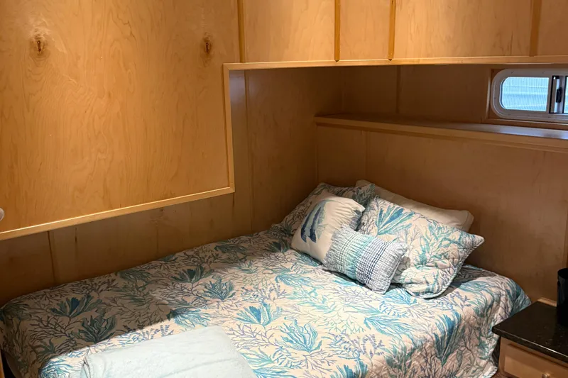 Slide: The Image of Cozy bedroom in STARDUST Oceans Share #2, 2015, with ocean-themed bedding and wooden walls. - 51