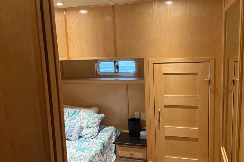 Slide: The Image of Cozy bedroom in 2015 STARDUST Oceans Share #2 houseboat with wooden interior and floral bedding. - 54