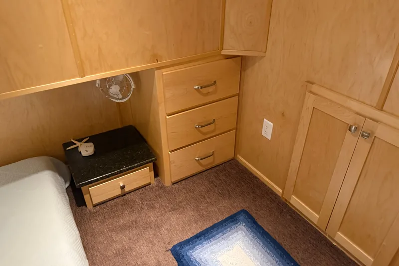 Slide: The Image of Cozy wooden interior with drawers, carpet, and a small fan in STARDUST Oceans Share #2, 2015. - 55