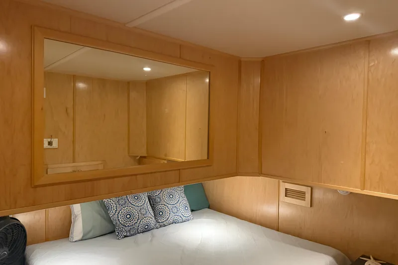 Slide: The Image of Cozy wooden cabin interior with bed, mirror, and decorative pillows in STARDUST Oceans Share #2, 2015. - 56