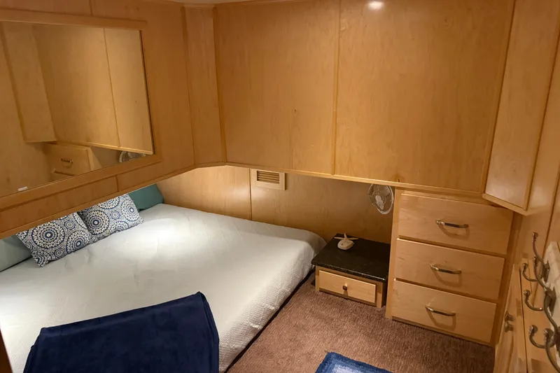 Slide: The Image of Cozy bedroom in STARDUST Oceans Share #2 houseboat, featuring wooden cabinetry and a comfortable bed. - 58
