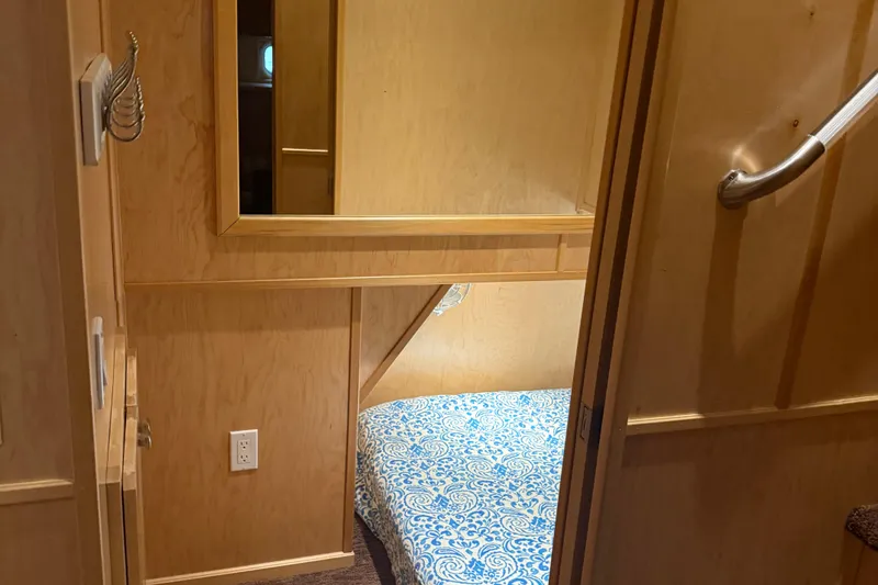 Slide: The Image of Compact wooden cabin interior with blue patterned bedding, STARDUST Oceans Share #2, 2015 model. - 61