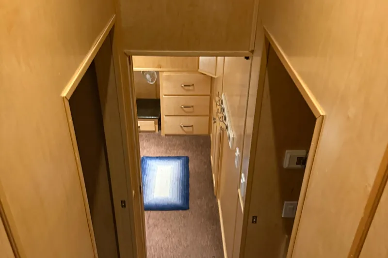 Slide: The Image of Narrow hallway in STARDUST Oceans Share #2, 2015 model, featuring wooden cabinetry and blue rug. - 63