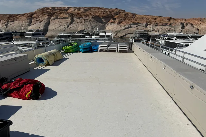 Slide: The Image of Rooftop deck of STARDUST Oceans Share #2 houseboat, featuring kayaks and lounge chairs, 2015. - 67