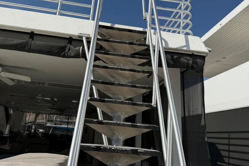 Slide: The Image of Staircase on STARDUST Oceans Share #2 houseboat, 2015 model, under clear blue sky. - 70