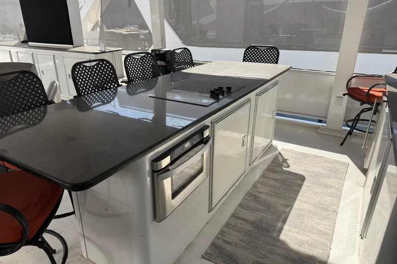 Slide: The Image of Modern kitchen area on STARDUST Oceans Share #2, 2015, with sleek countertops and seating. - 83