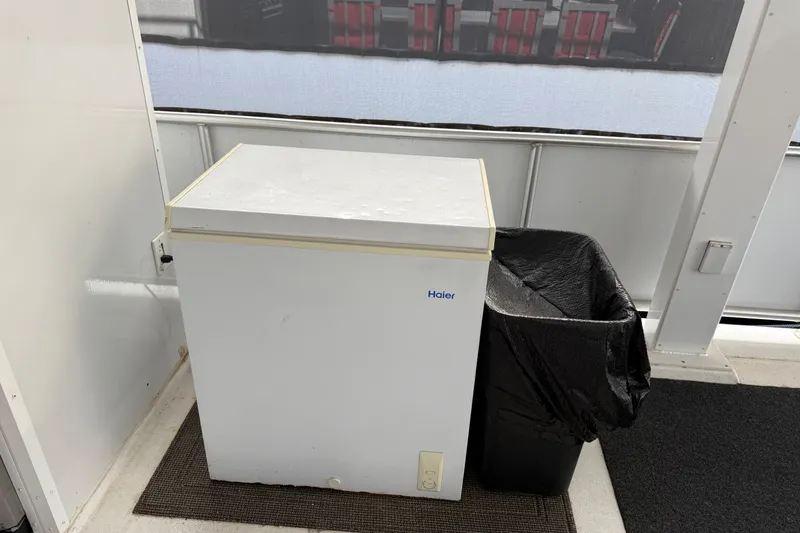 Slide: The Image of White Haier freezer beside black trash bin on a boat deck, STARDUST Oceans Share #2, 2015. - 86