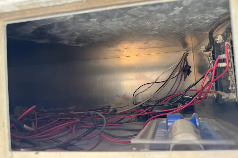 Slide: The Image of Wiring compartment of a 2011 Pro-Line 20 CC boat, showing cables and connections. - 15