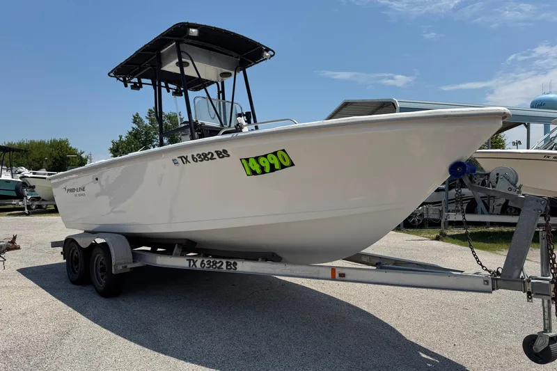Slide: The Image of 2011 Pro-Line 20 CC boat on trailer, displayed outdoors with price tag. - 3