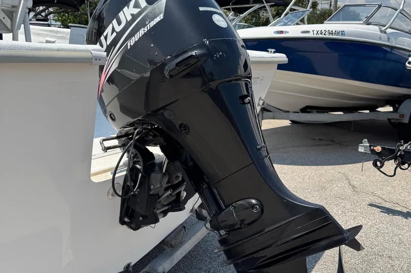 Slide: The Image of 2011 Pro-Line 20 CC boat with Suzuki four-stroke outboard motor, parked on a trailer. - 4