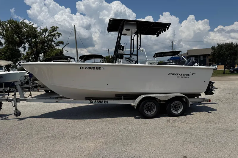 Slide: The Image of 2011 Pro-Line 20 CC boat on trailer, parked outdoors under cloudy sky. - 5