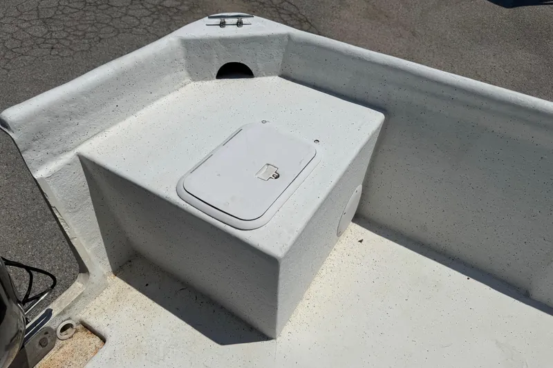 Slide: The Image of 2011 Pro-Line 20 CC boat deck with storage compartment, white speckled finish. - 7