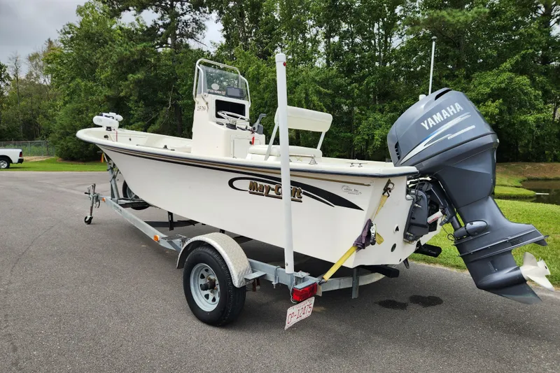 Slide: The Image of 2008 May-Craft 1800 Skiff boat on trailer with Yamaha outboard motor, parked outdoors. - 2
