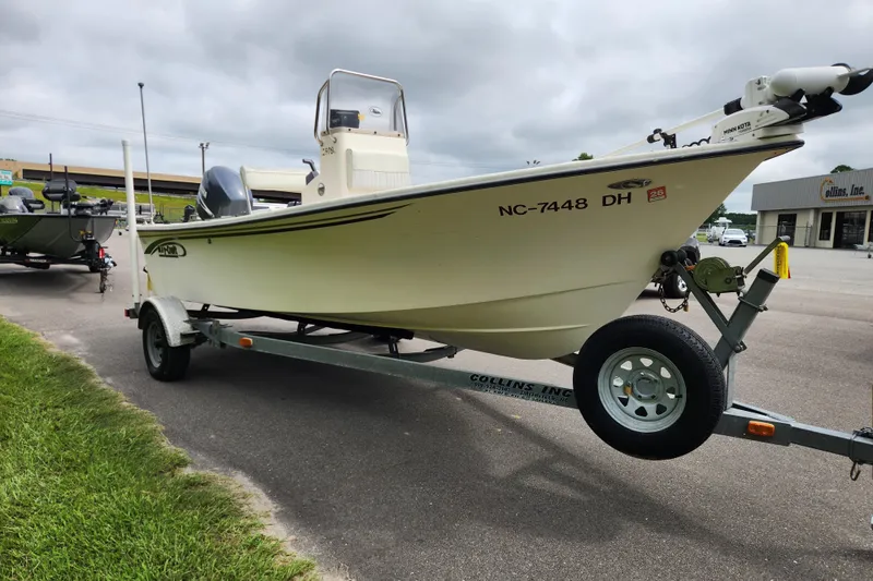 Slide: The Image of 2008 May-Craft 1800 Skiff on trailer, parked outdoors near a dealership. - 6
