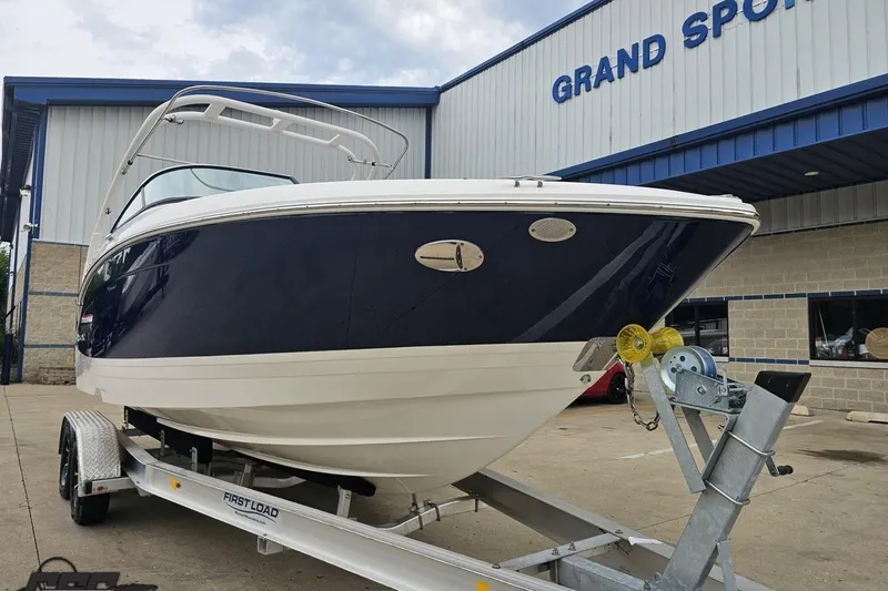Slide: The Image of 2021 Regal LX4 boat on trailer at Grand Sports facility. - 14