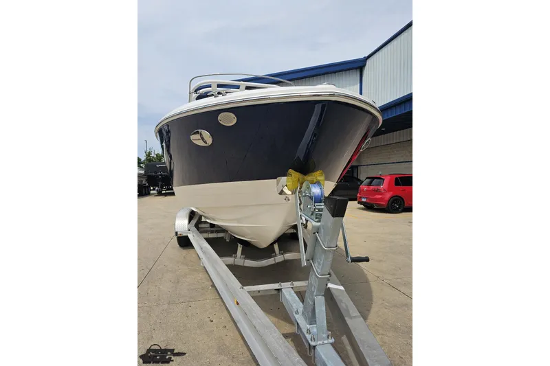 Slide: The Image of 2021 Regal LX4 boat on trailer, parked outdoors near a building. - 15