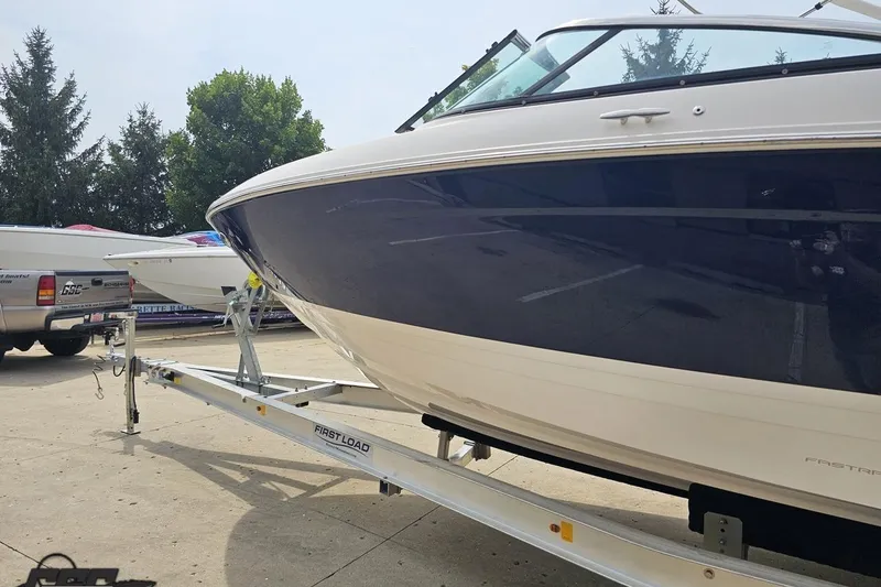 Slide: The Image of 2021 Regal LX4 boat on trailer, parked outdoors, showcasing sleek design. - 21