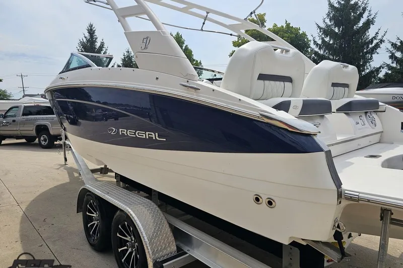 Slide: The Image of 2021 Regal LX4 boat on trailer, featuring sleek design and comfortable seating. - 25