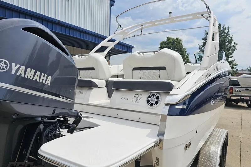 Slide: The Image of 2021 Regal LX4 boat with Yamaha engine, parked outdoors on a trailer. - 29