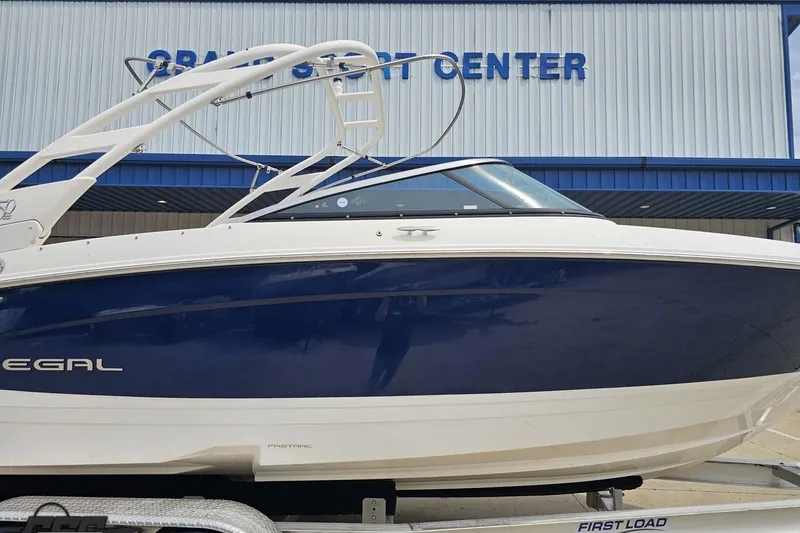 Slide: The Image of 2021 Regal LX4 boat in blue and white at a marine sport center. - 3