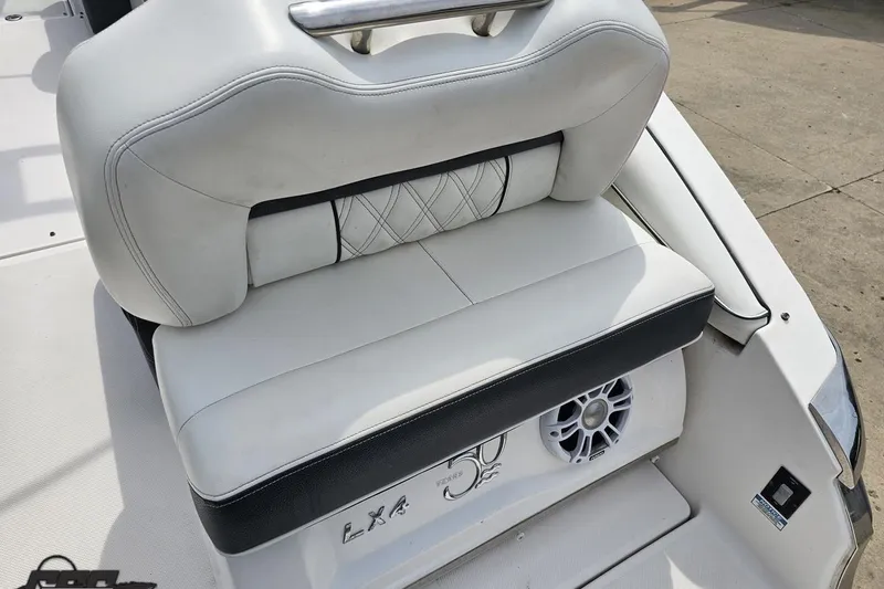 Slide: The Image of 2021 Regal LX4 boat seat with white upholstery and integrated speaker. - 35