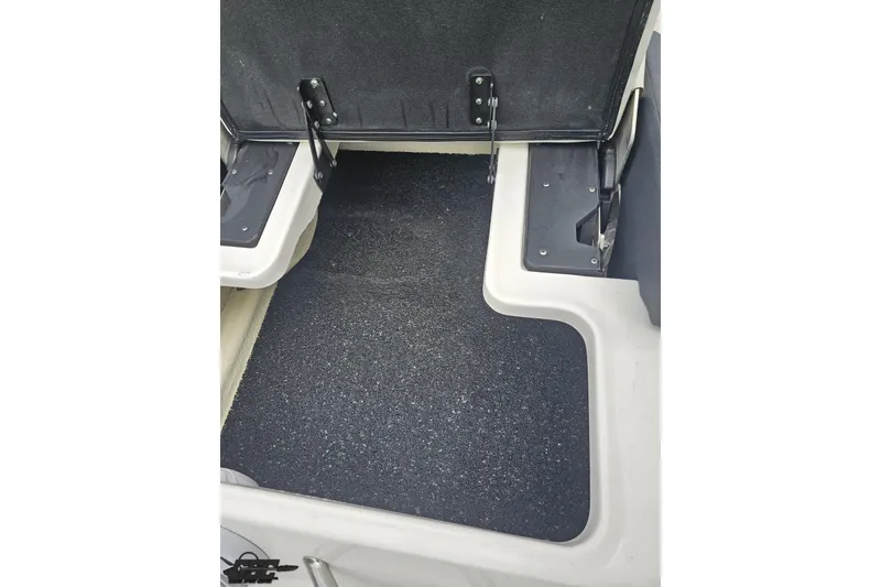 Slide: The Image of 2021 Regal LX4 boat interior storage compartment with black non-slip flooring. - 38