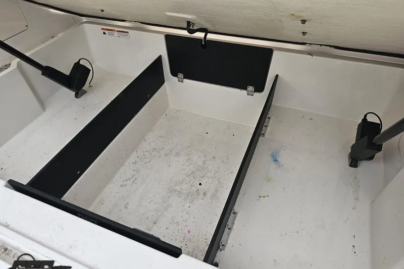 Slide: The Image of 2021 Regal LX4 boat storage compartment, open and empty, with visible hydraulic supports. - 40