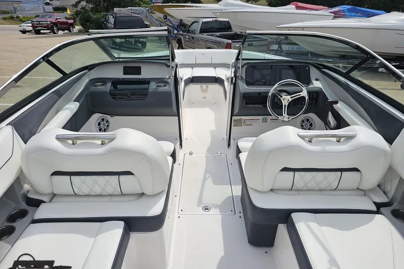 Slide: The Image of 2021 Regal LX4 boat interior with white seating and modern dashboard. - 43