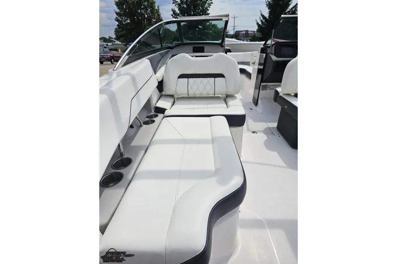 Slide: The Image of 2021 Regal LX4 boat interior with white leather seating and cup holders. - 45