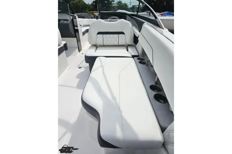 Slide: The Image of 2021 Regal LX4 boat interior with white seating and cup holders. - 49
