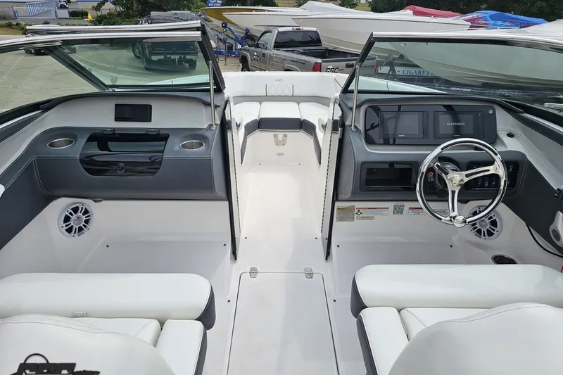 Slide: The Image of 2021 Regal LX4 boat interior with modern dashboard and steering wheel. - 51