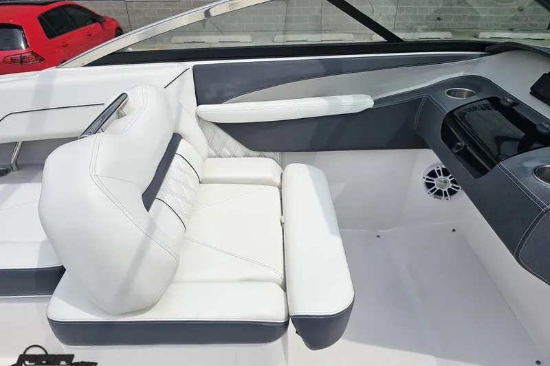 Slide: The Image of 2021 Regal LX4 boat interior with white seating and modern dashboard design. - 53