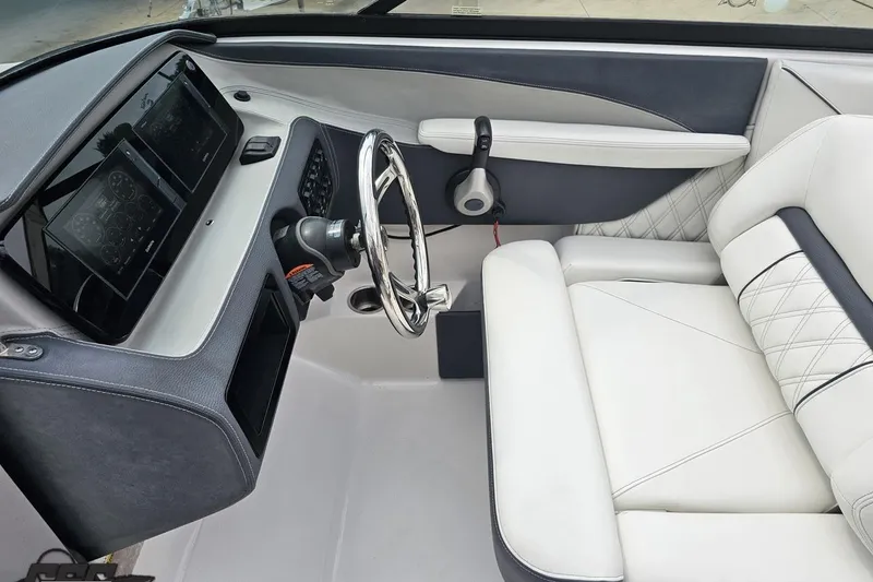 Slide: The Image of 2021 Regal LX4 boat interior with modern dashboard and luxurious white seating. - 60