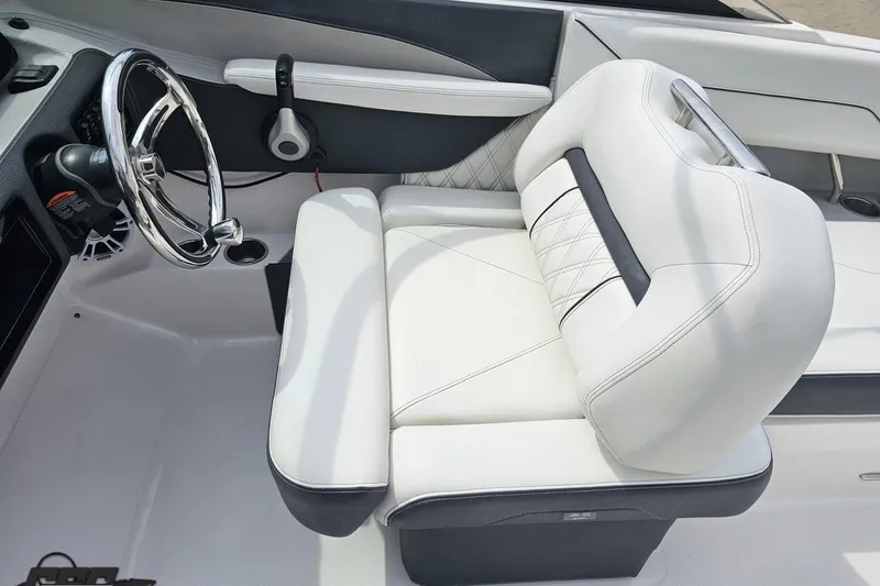 Slide: The Image of 2021 Regal LX4 boat interior with white leather seating and chrome steering wheel. - 61