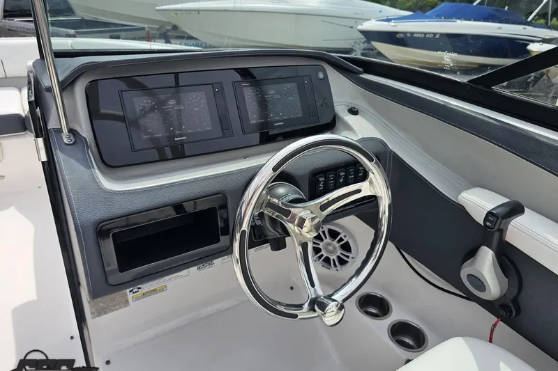 Slide: The Image of 2021 Regal LX4 boat dashboard with steering wheel and digital displays. - 63