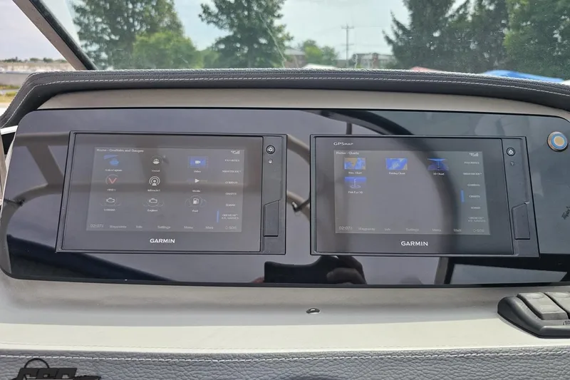 Slide: The Image of 2021 Regal LX4 dashboard featuring dual Garmin navigation screens. - 66