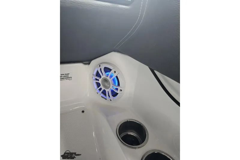 Slide: The Image of 2021 Regal LX4 boat interior with illuminated speaker and cup holders. - 68