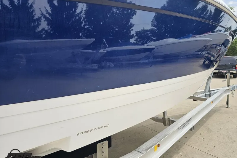 Slide: The Image of 2021 Regal LX4 boat on trailer, featuring blue and white hull with "FasTrac" branding. - 7
