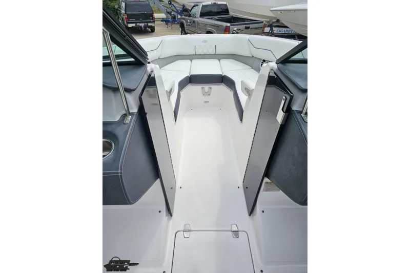 Slide: The Image of 2021 Regal LX4 boat interior with white seating and open deck view. - 72
