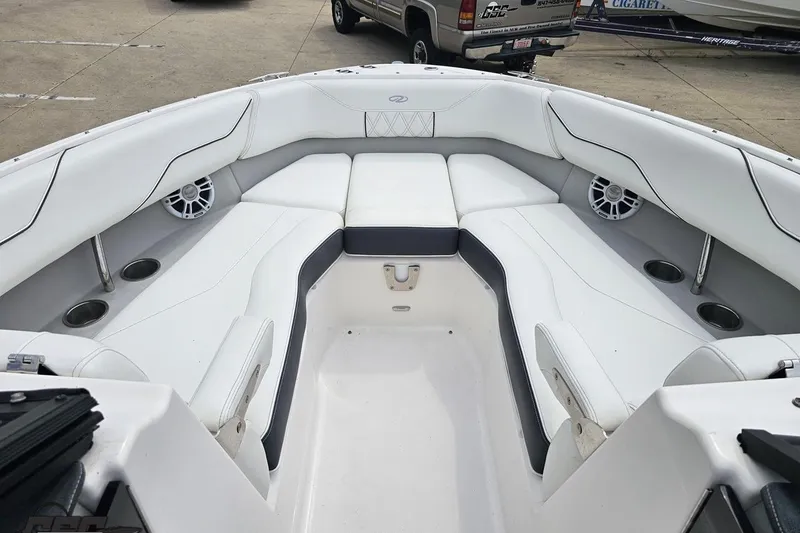 Slide: The Image of Luxurious 2021 Regal LX4 boat interior with white seating and cup holders. - 74