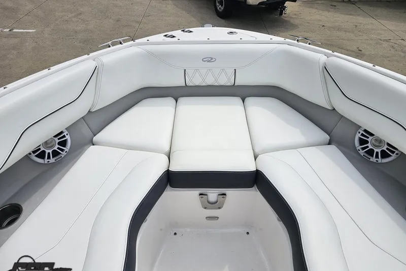 Slide: The Image of Luxurious 2021 Regal LX4 boat interior with white cushioned seating and speakers. - 76