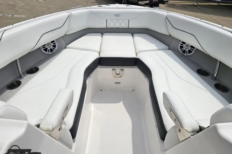 Slide: The Image of 2021 Regal LX4 boat interior with white seating and built-in speakers. - 77
