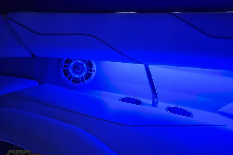 Slide: The Image of 2021 Regal LX4 interior with blue LED lighting, featuring speaker and cup holders. - 79