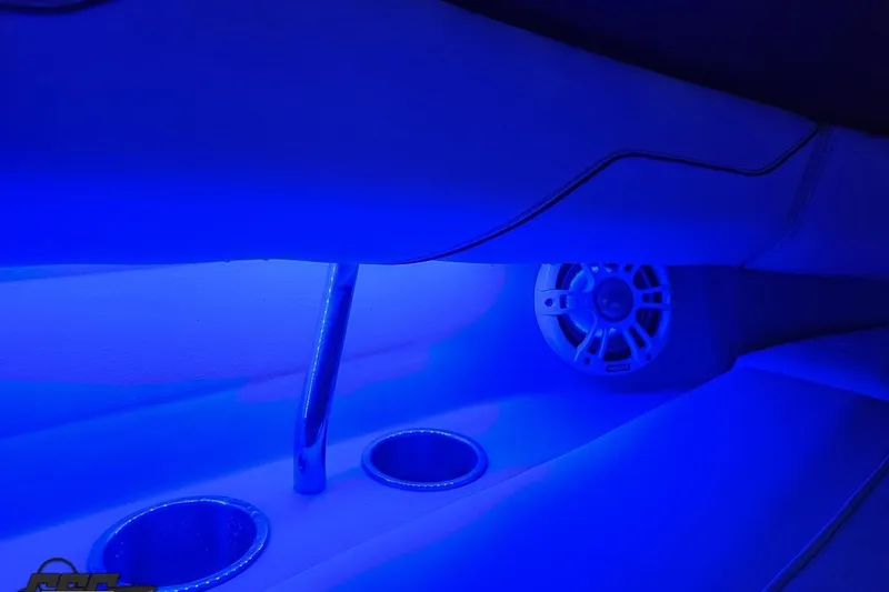 Slide: The Image of 2021 Regal LX4 interior with blue LED lighting, featuring cup holders and speaker. - 80