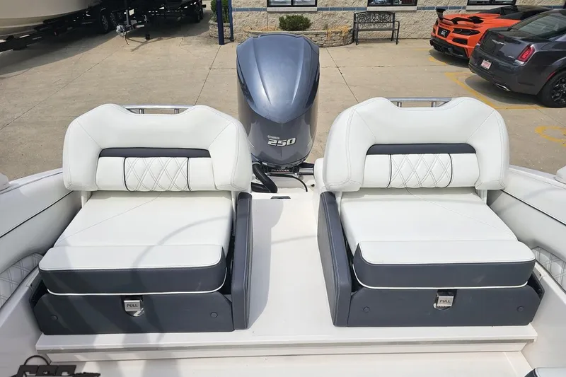 Slide: The Image of 2021 Regal LX4 boat interior with dual white cushioned seats and Yamaha 250 engine. - 86