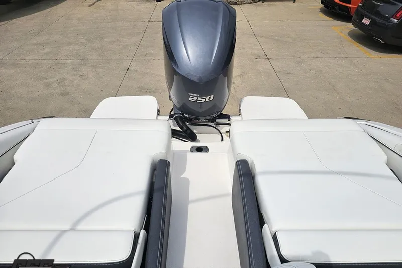 Slide: The Image of 2021 Regal LX4 boat with Yamaha 250 outboard engine, white seating, parked on concrete. - 88